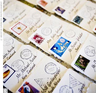 To complement their travel theme, Kiana and Brian decorated their escort cards with passport stamps and postal stamps from each featured country, which they had acquired during their worldly travels.