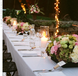 Lush arrangements of roses, peonies, hydrangeas, and ranunculus lined the reception tables. Large candles added an intimate glow to the space.