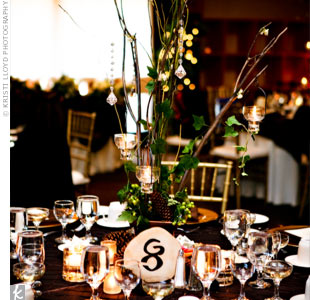 The centerpieces reflected the couple’s woodsy theme while also 
